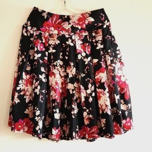 Roz & Ali pink floral pleated skirt with Black Background
